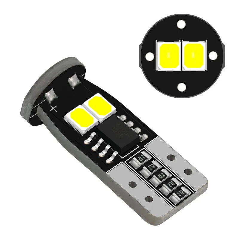 Small white LED car lamp for licence plate lighting on a fibre-glass board.