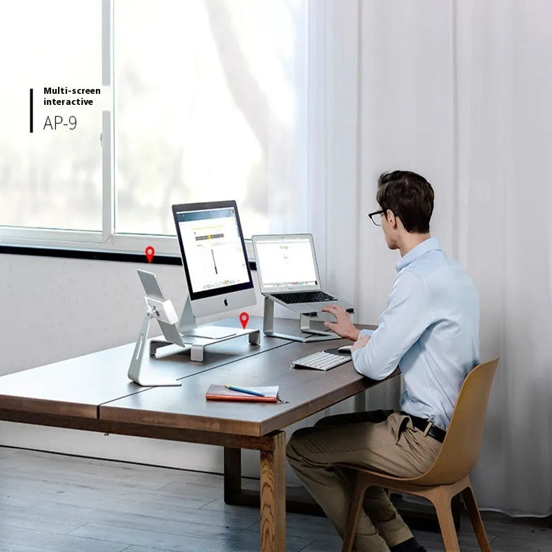 Black aluminium alloy laptop stand on desk with laptop elevated for cooling