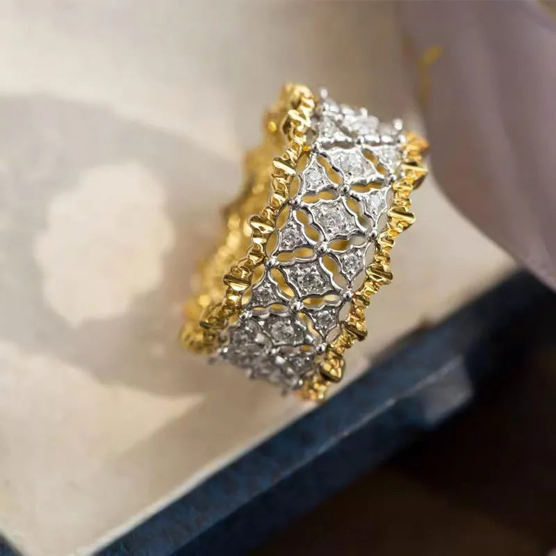 Geometric round two-tone gold zircon ring on a plain background, showing its electroplated copper construction.