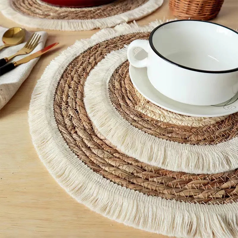 Round papyrus straw placemat with decorative tassels in modern solid colour design