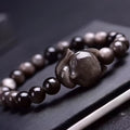 Obsidian fox bracelet with 8mm black beads and silver fox charm on adjustable black cord