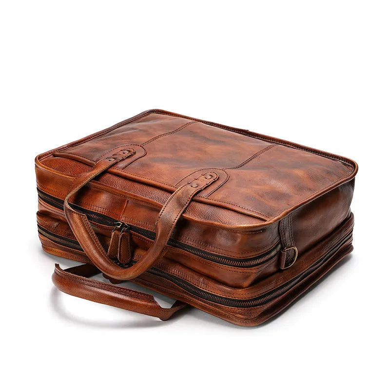 Large brown leather men's briefcase showing multiple internal compartments and organisation pockets