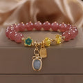 Red strawberry quartz and rhinestone beaded bracelet with an alloy clasp.