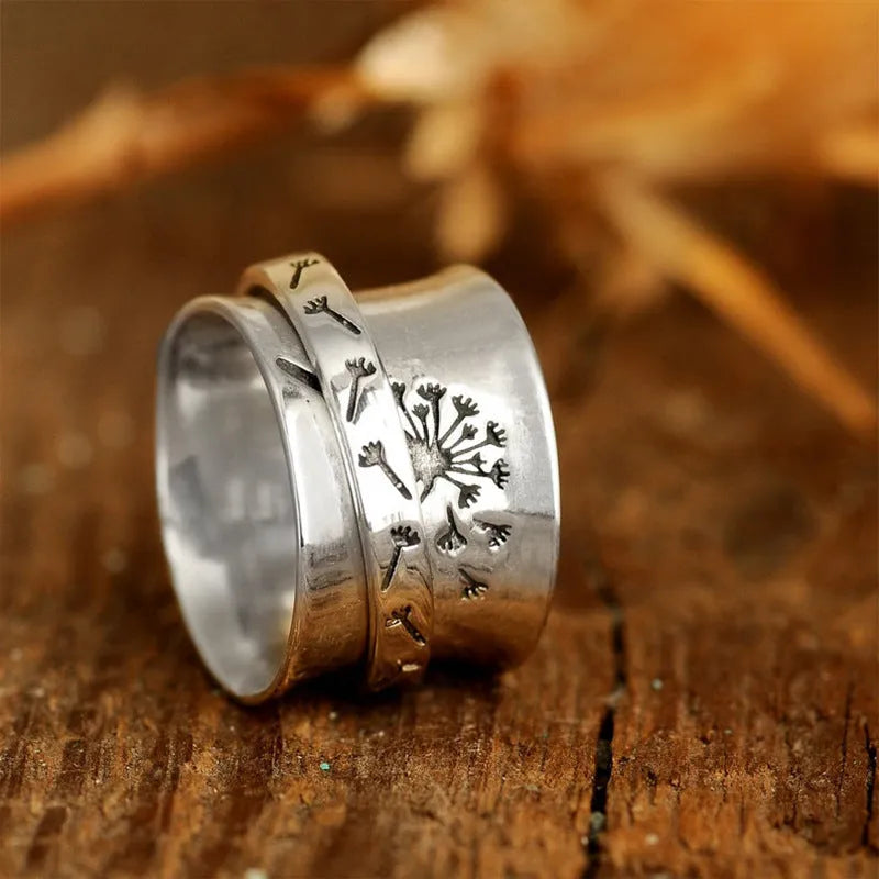 Silver tone floral fashion ring with rotatable flower element on alloy band