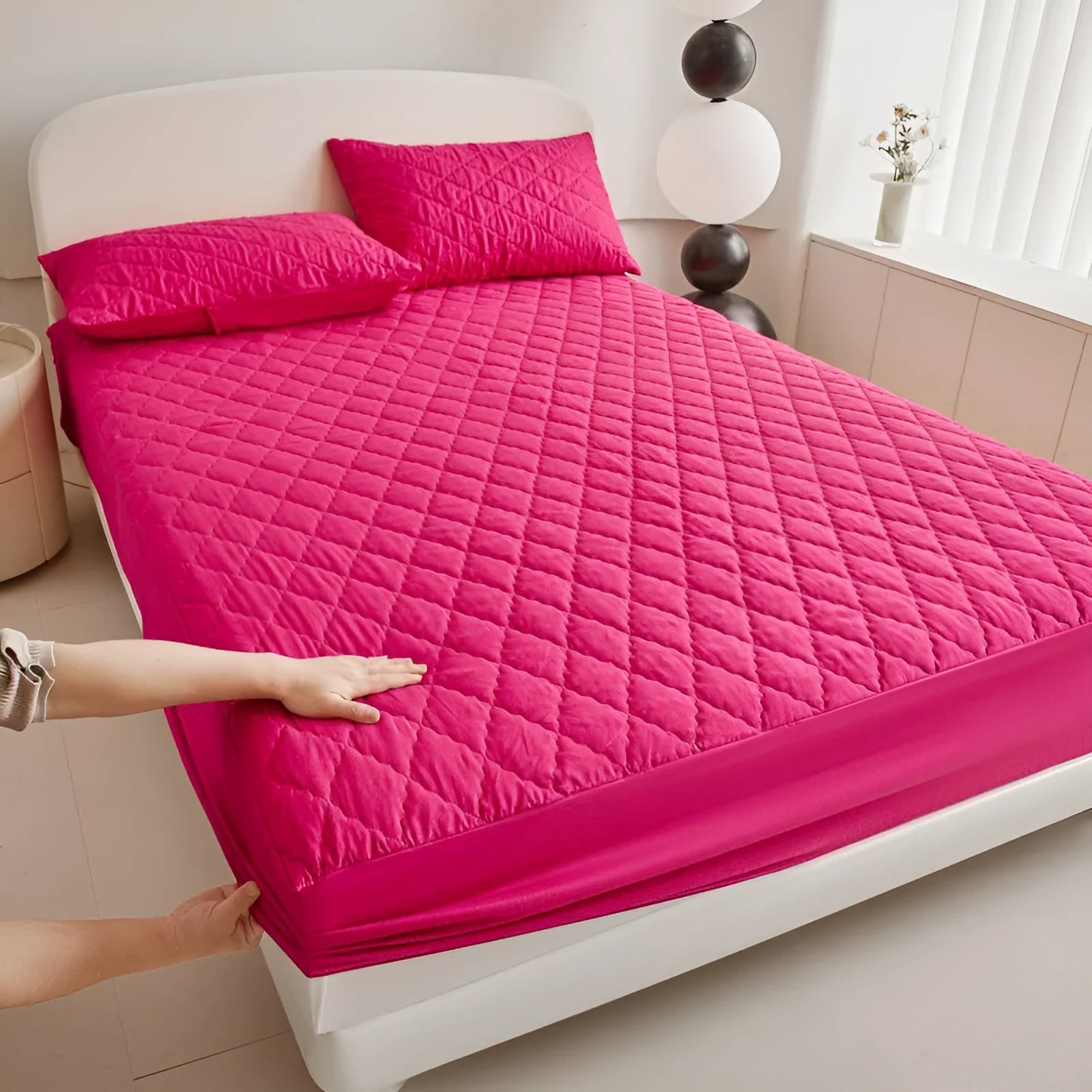 Diamond lattice quilted waterproof mattress protector in bamboo fibre shown on bed