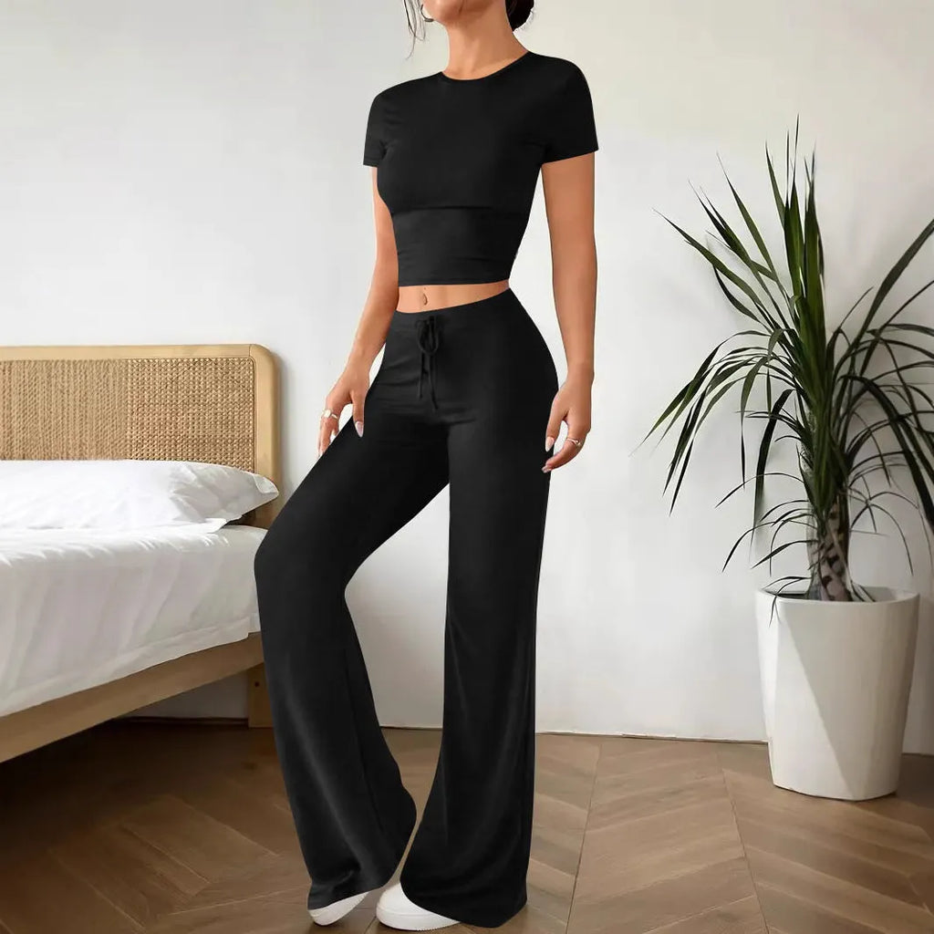 Black high-waist trousers and short sleeve t-shirt co-ord set for women.