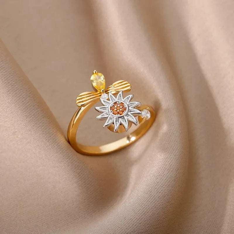 Rotatable decompression ring with adjustable opening in gold electroplated finish