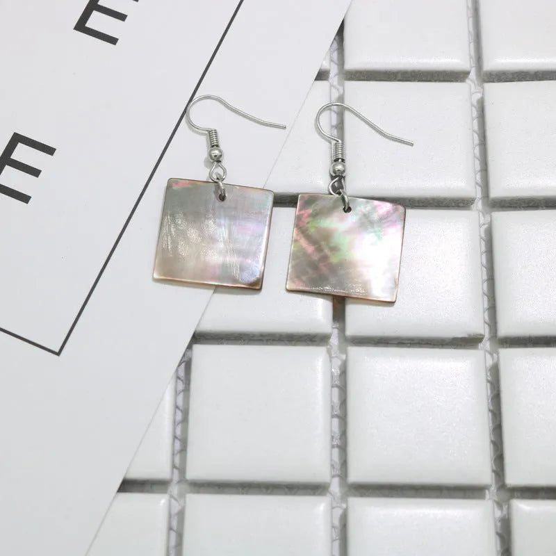 Women's geometric shell earrings in square panther or rectangular shell designs with natural material texture