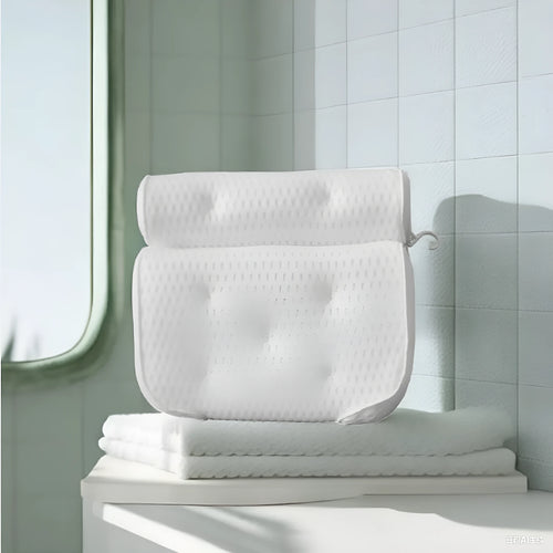 White 3D mesh bathtub pillow with seven suction cups on a bathtub.
