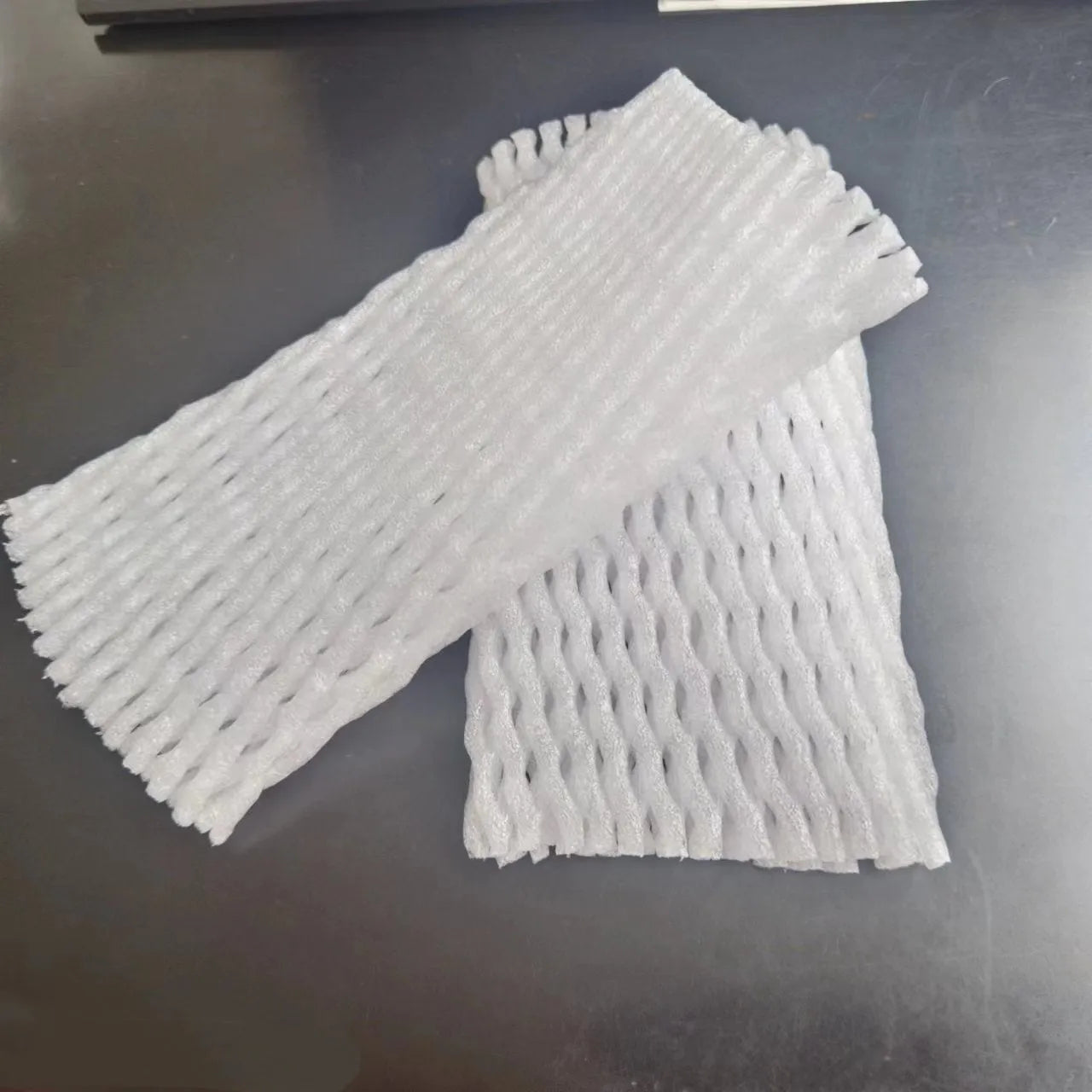 White foam net protective cover shown in various sizes for cushioning fruit and fragile items.