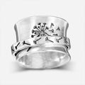 Silver tone floral fashion ring with rotatable flower element on alloy band