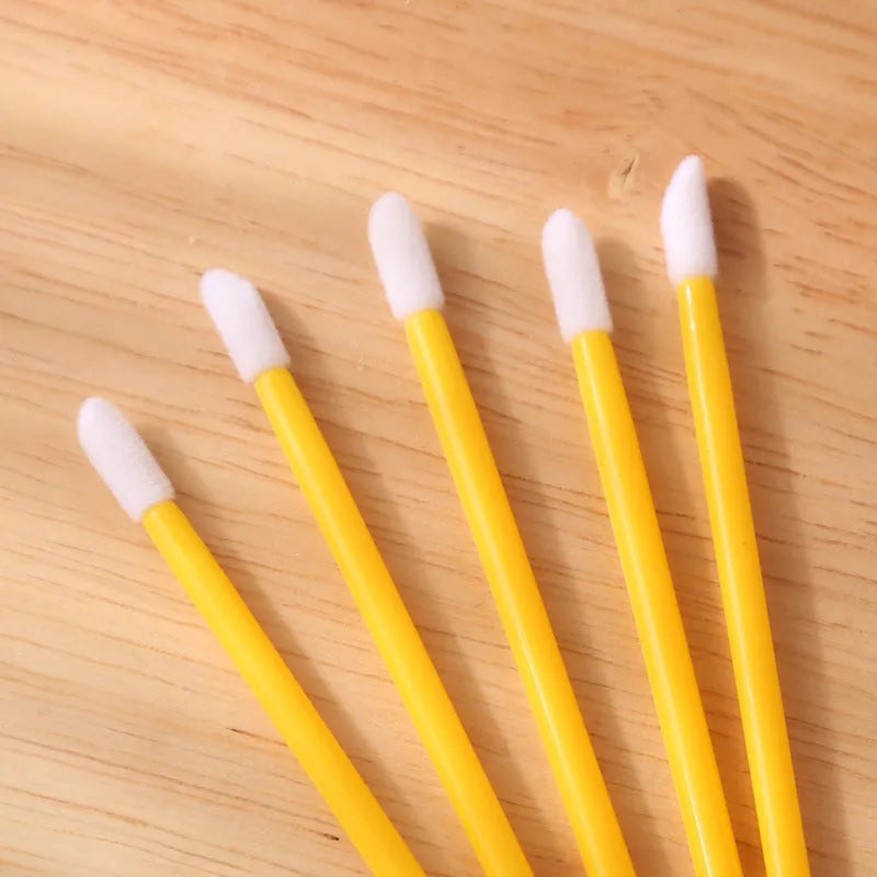 Disposable lip brushes with flocked heads and black handles in various colours
