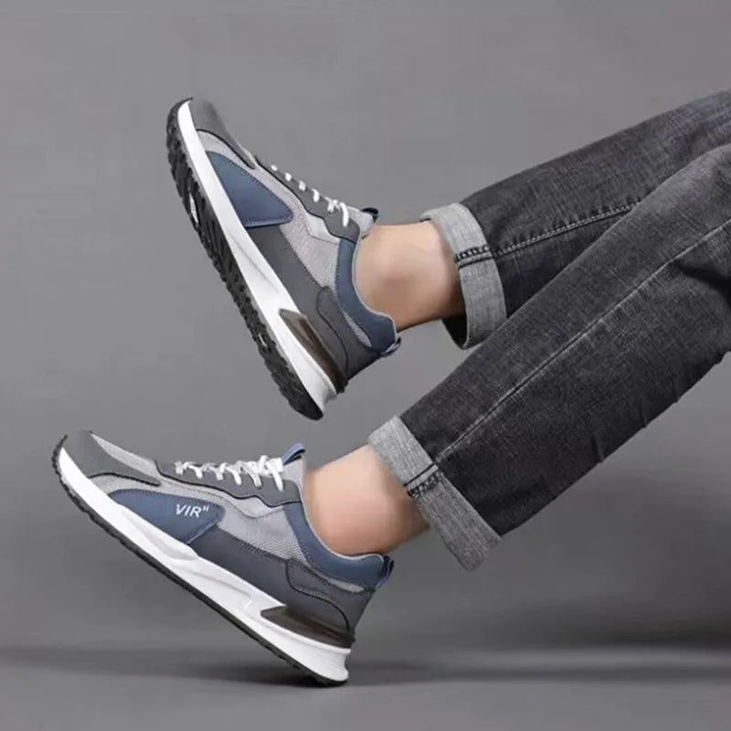 Men's colour block mesh running sneakers in black, grey, and white on a plain background.