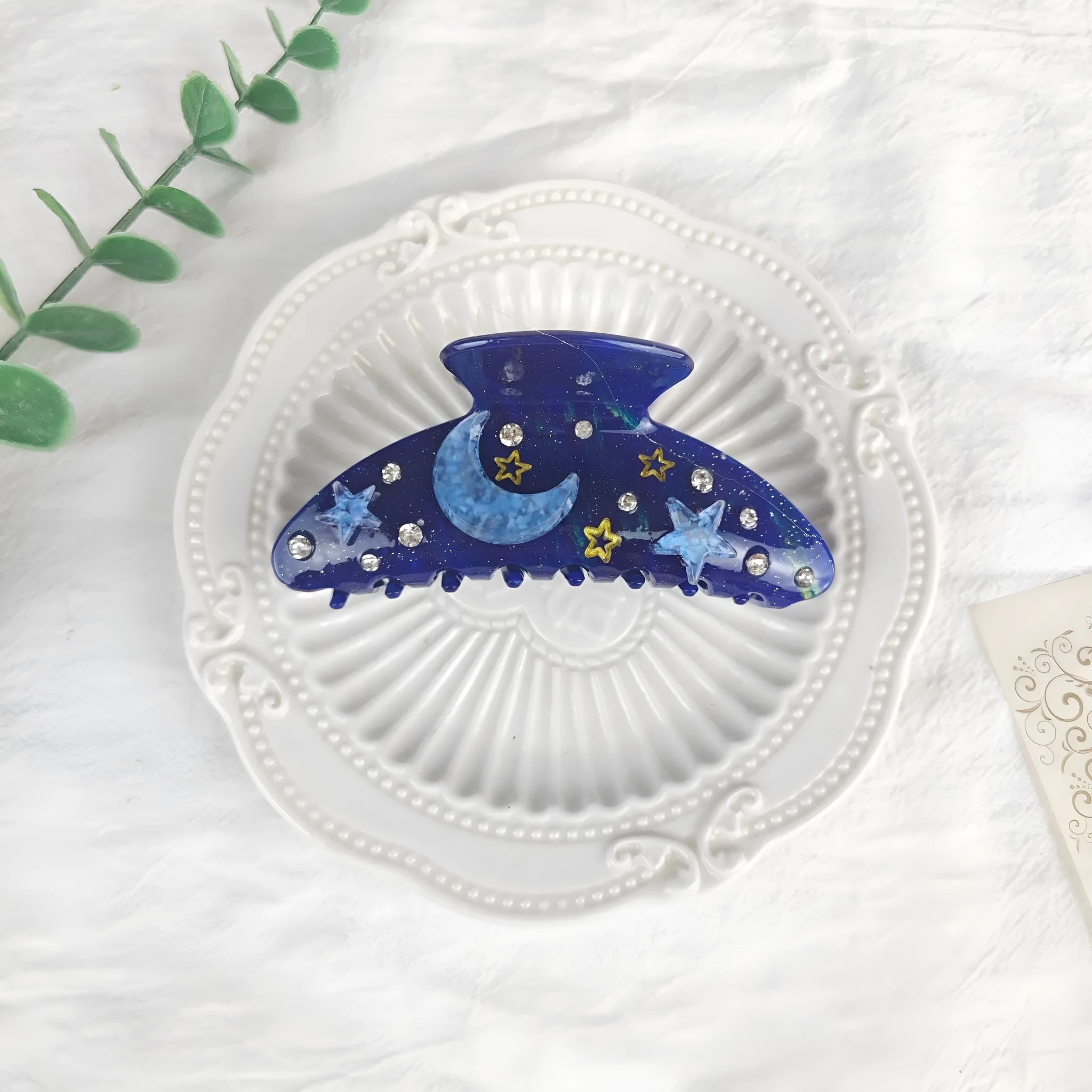 Oversized women's barrette with a starry sky design in blue, made from cellulose acetate sheet.