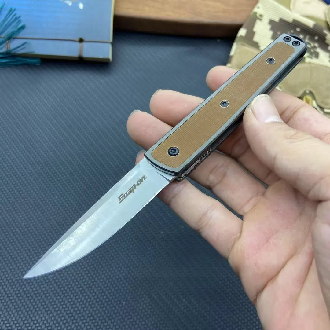 Folding fruit knife with stainless steel blade in black, brown, or red colour options showing closed and open positions