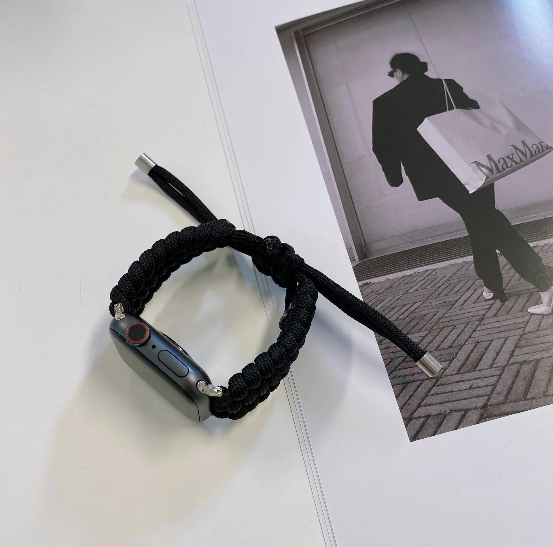 Paracord braided smartwatch strap in black, shown fitting an Apple Watch.
