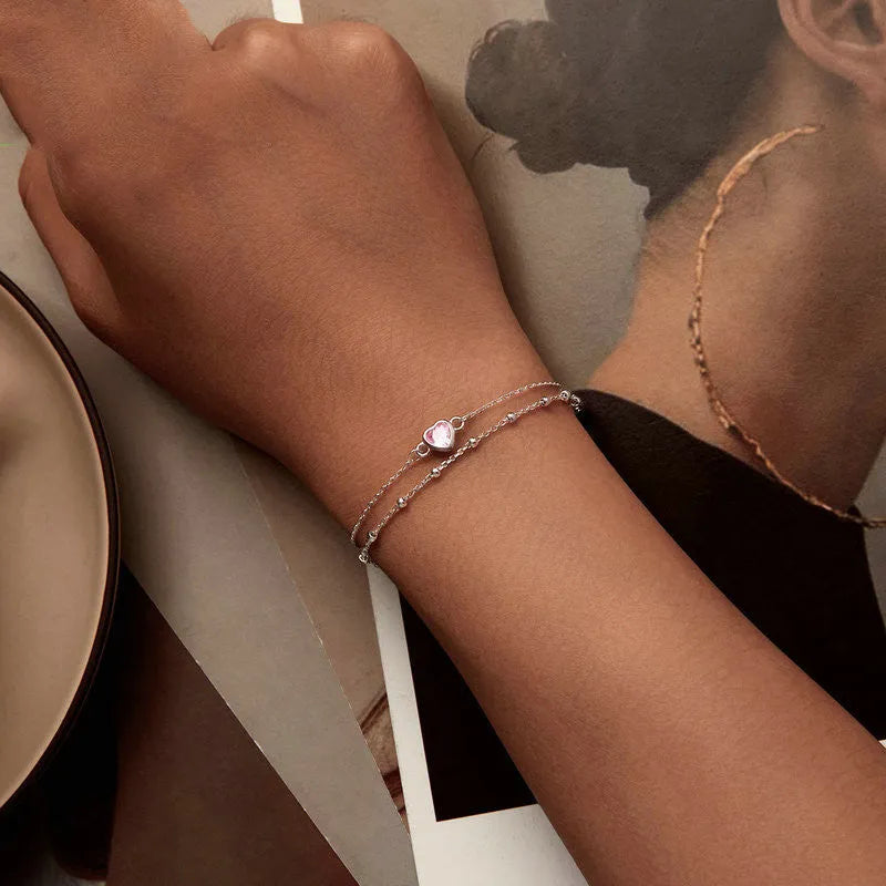 Women's 925 sterling silver bracelet with a small heart charm on an adjustable chain.
