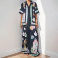 Black women's casual set with cartoon pattern featuring cardigan-sleeve top and matching trousers