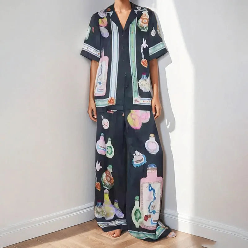 Black women's casual set with cartoon pattern featuring cardigan-sleeve top and matching trousers