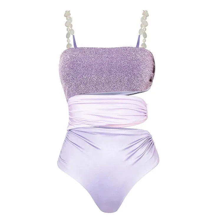 Purple one-piece swimsuit with hollow design and matching wrap skirt on white background
