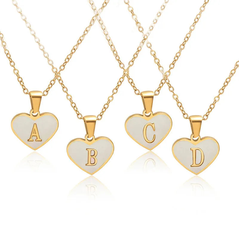 Gold plated heart-shaped necklace with white shell pendant on adjustable stainless steel chain