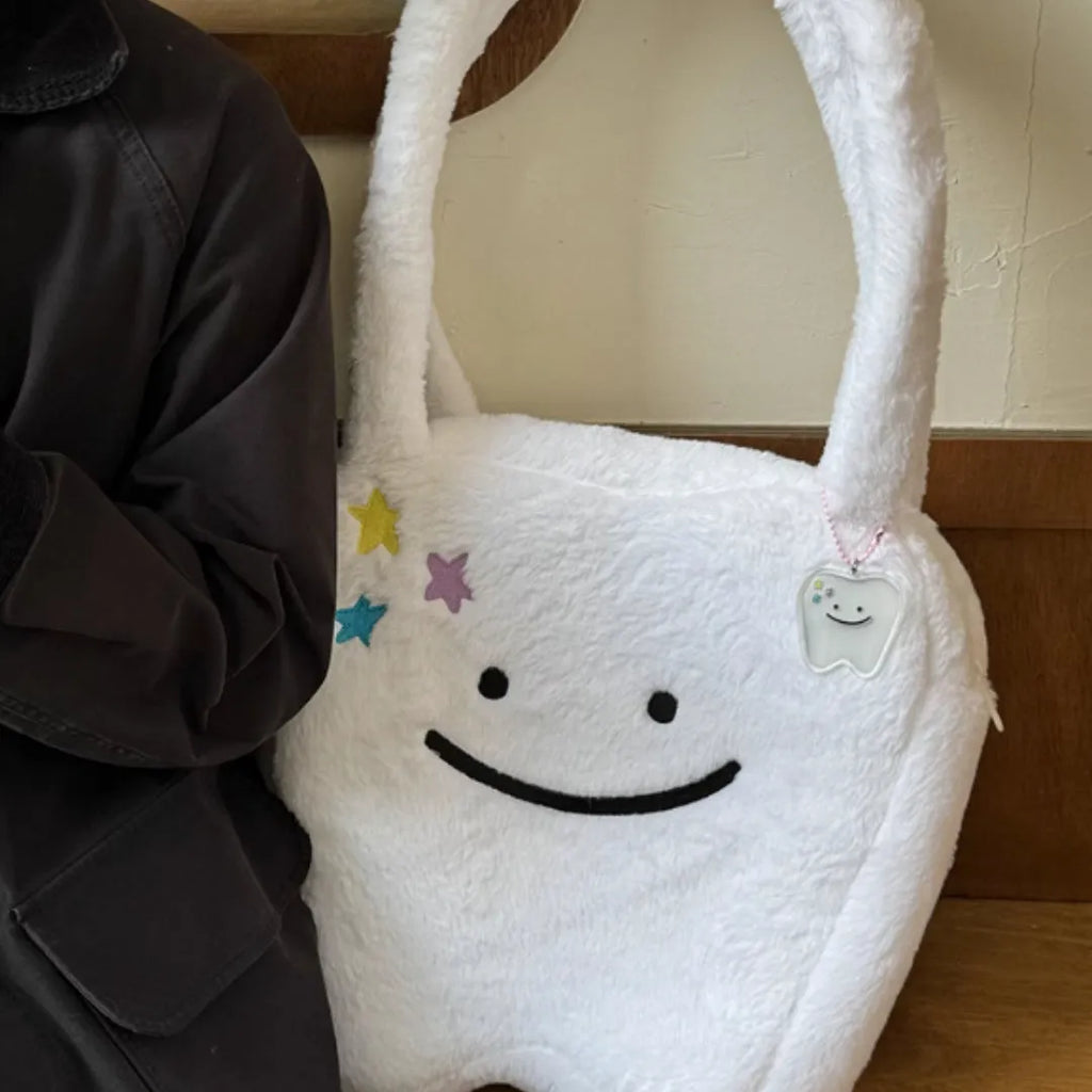 White plush large tooth shoulder tote bag with crossbody strap and zipper closure