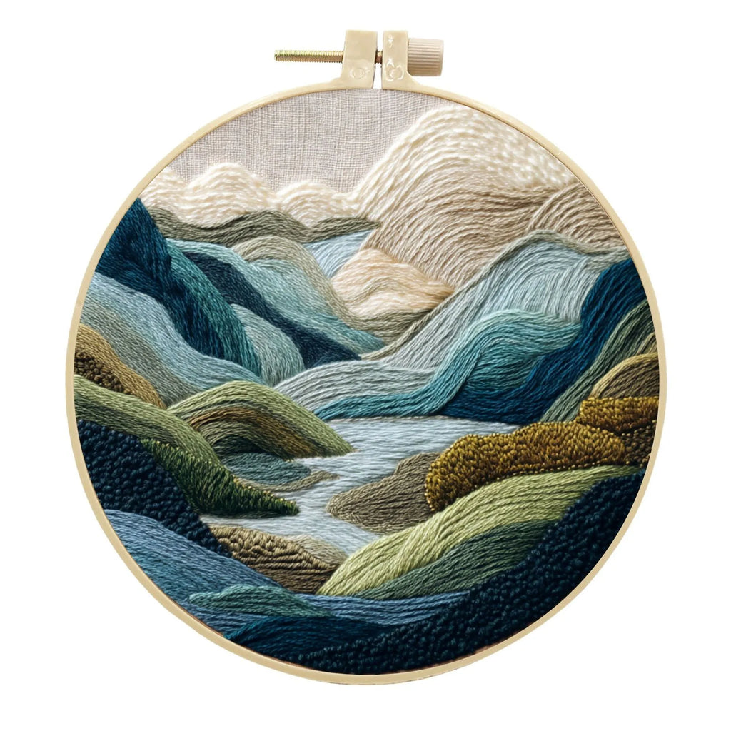Embroidery kit with cotton fabric, bamboo frame, threads, and printed landscape design for DIY textile art