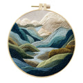 Embroidery kit with cotton fabric, bamboo frame, threads, and printed landscape design for DIY textile art