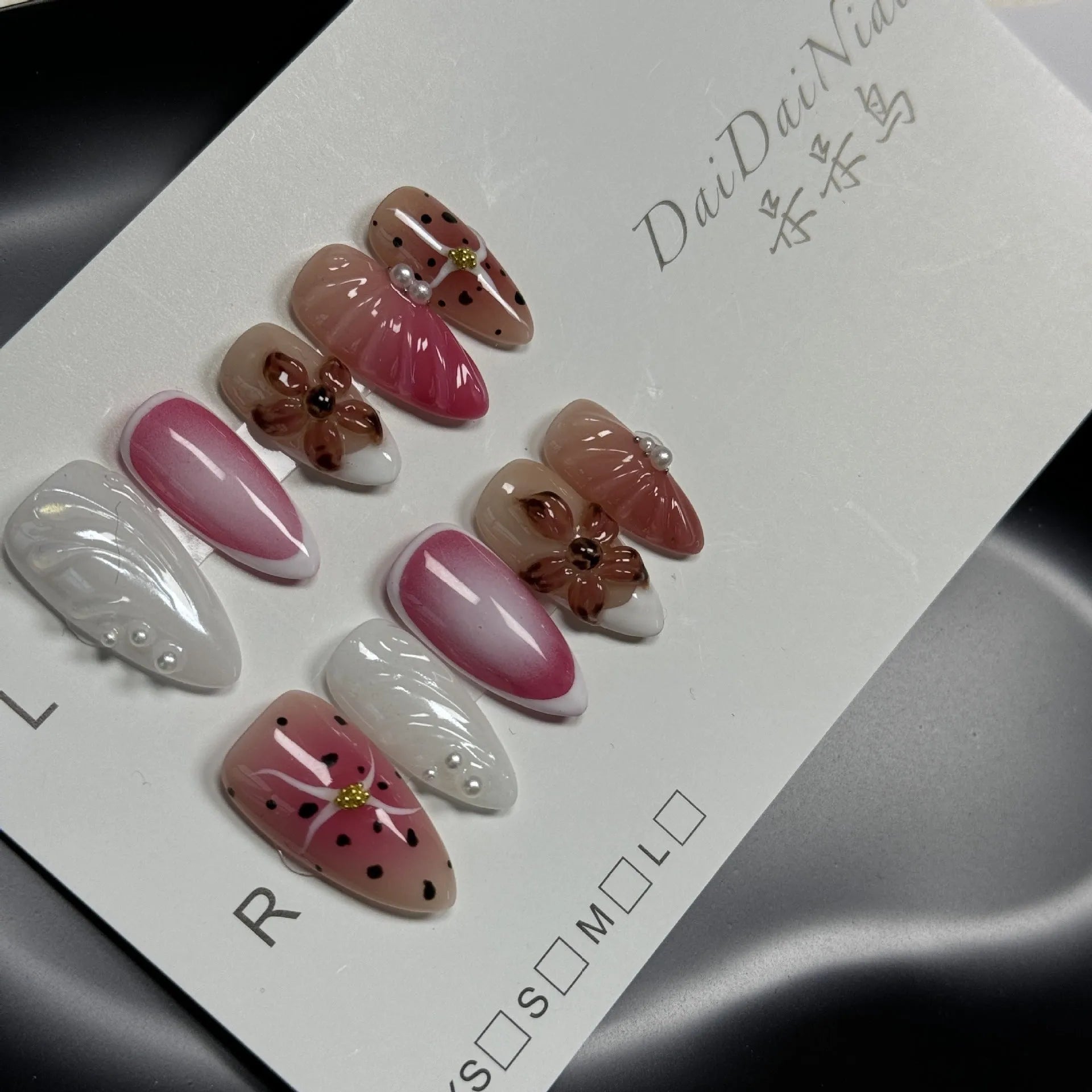 Hand-painted three-dimensional carved nail art patches in embossed candy colours, showing almond shape.