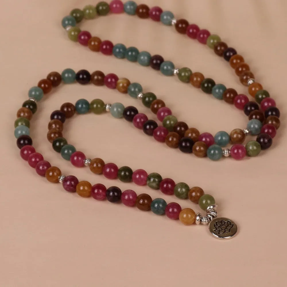 108 bead multi-layer bracelet with lotus pendant in Tourmaline colour and alloy construction.