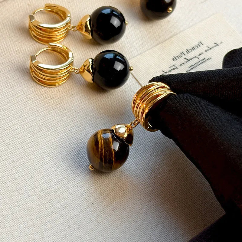 Tigereye geometric earrings with gold plating in brown or black colours featuring circular French retro design