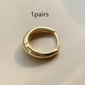 Women's geometric water drop earrings in gold and silver with minimalist round design
