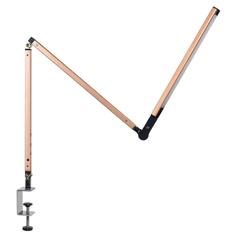 Folding aluminium desk lamp with a metal clip, shown in dazzling black, attached to a desk edge.