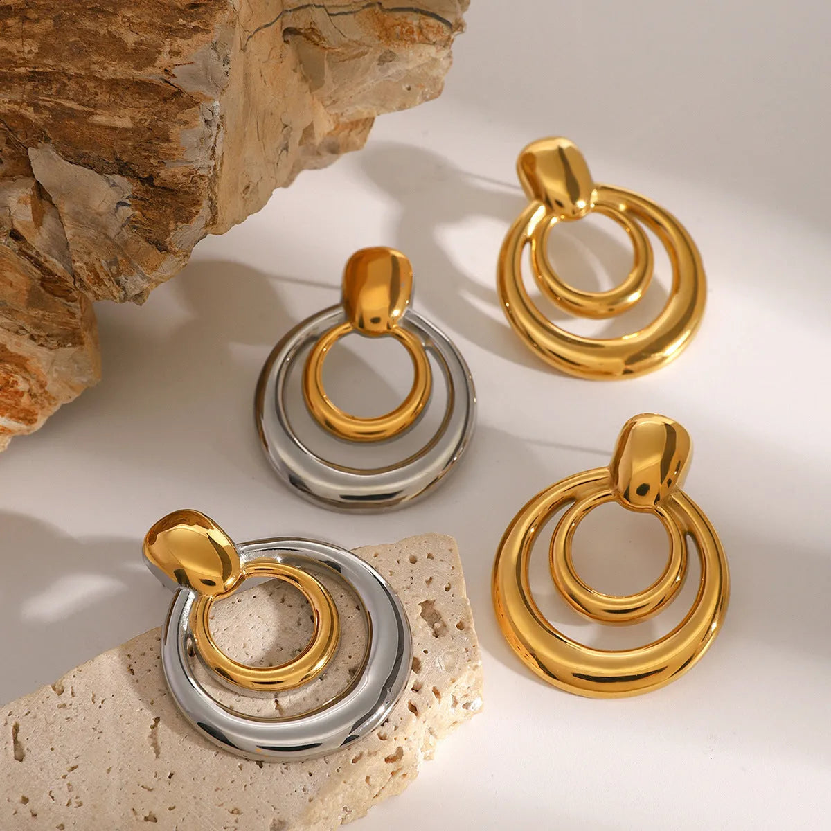 Round double layer hollow stud earrings with gold electroplated surface on titanium steel
