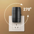 Small white adjustable plug-in night lamp with rotatable head shown in a bedside socket