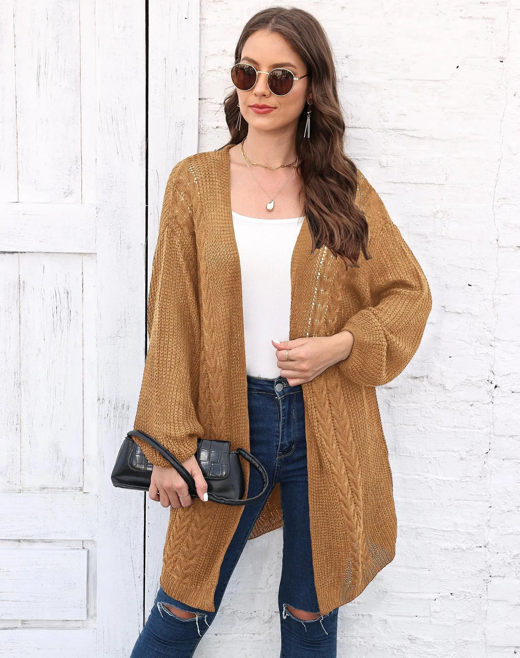 Women's loose brown acrylic sweater coat hanging on a hanger