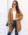 Women's loose brown acrylic sweater coat hanging on a hanger