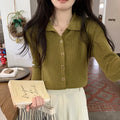 Beige loose fit long-sleeved viscose knitted cardigan top worn open as a layer.