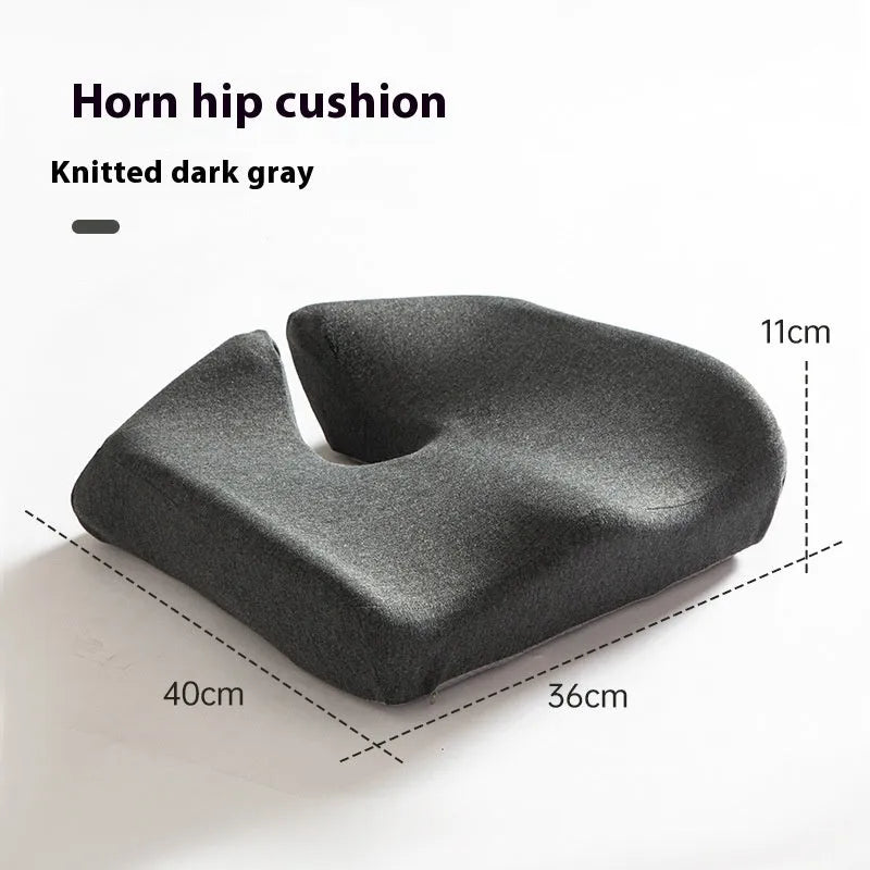 A solid grey memory foam office chair cushion for lumbar support.