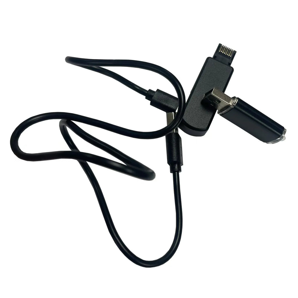 Black JB Tool USB gaming adapter with alloy construction next to its data cable and user manual.
