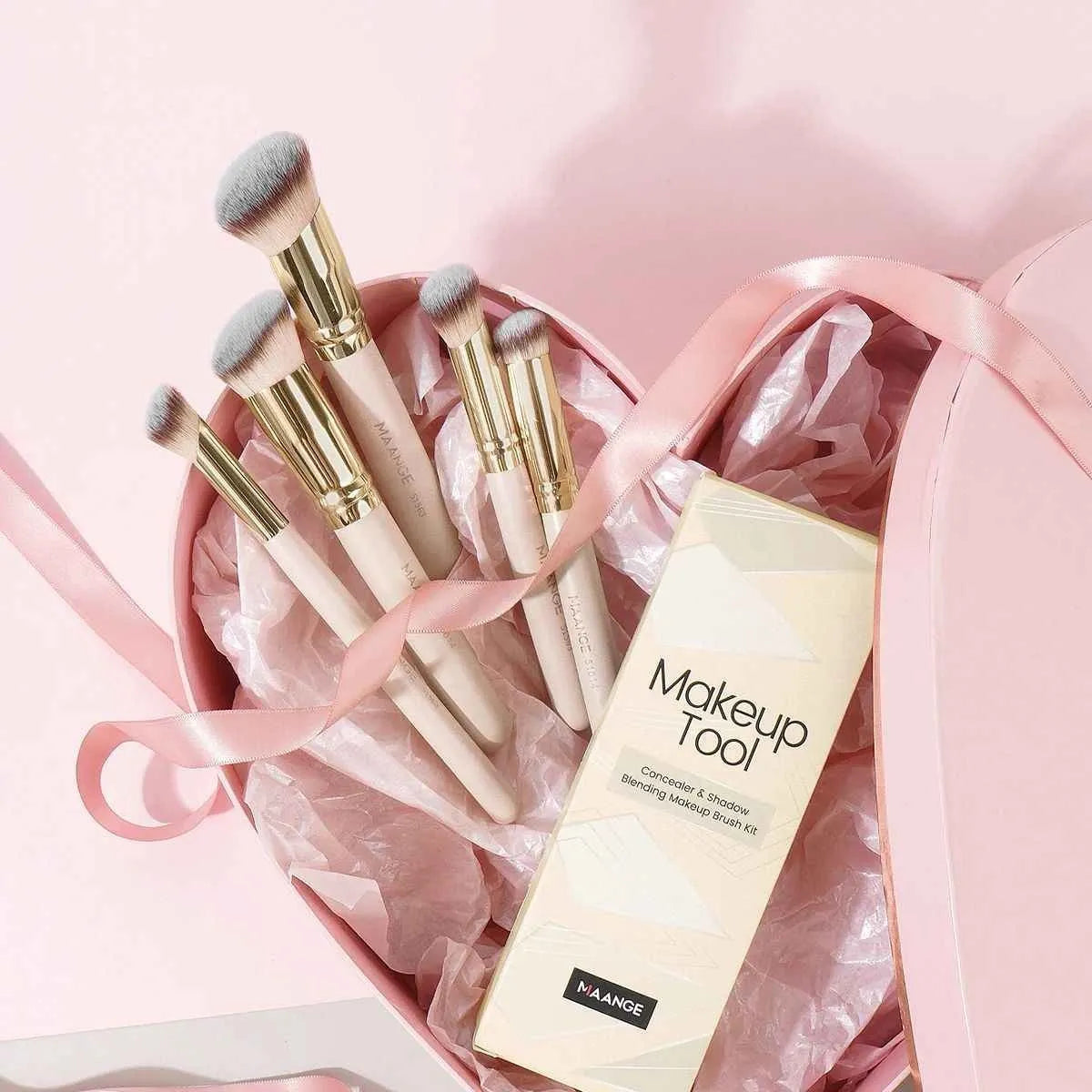 Five apricot-coloured makeup brushes with angled synthetic bristles for powder, blush and foundation application