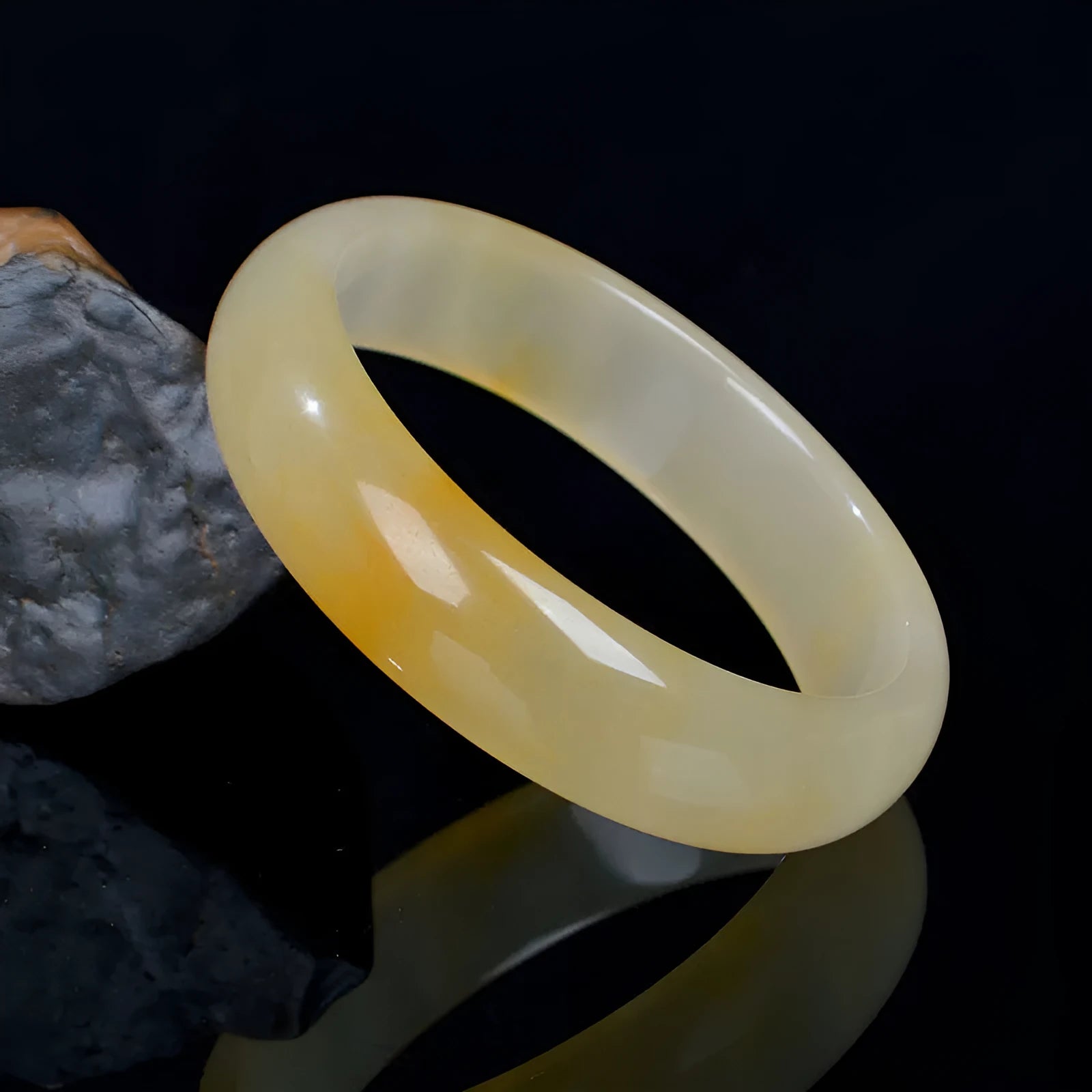 Natural light jade Chinese style bracelet on a white background showing polished finish.