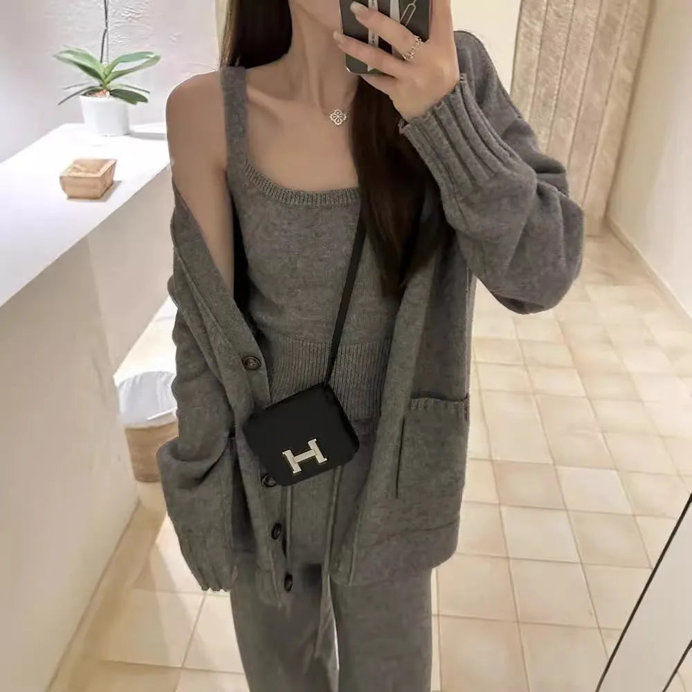 Women's loose fit knit cardigan, vest, and casual pants three-piece set in a solid colour.