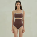 Brown women's one-piece swimsuit with triangle neckline on mannequin