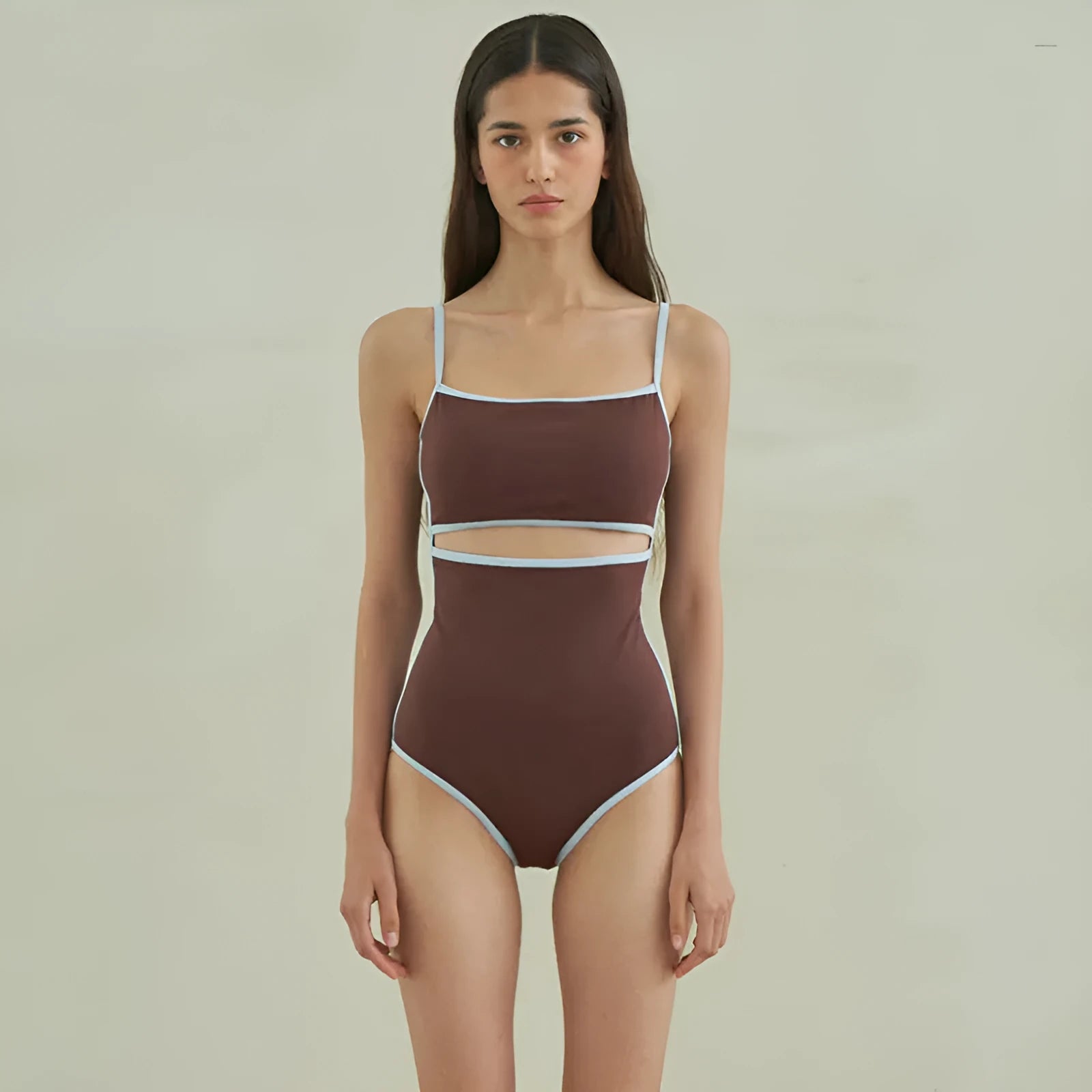 Brown women's one-piece swimsuit with triangle neckline on mannequin