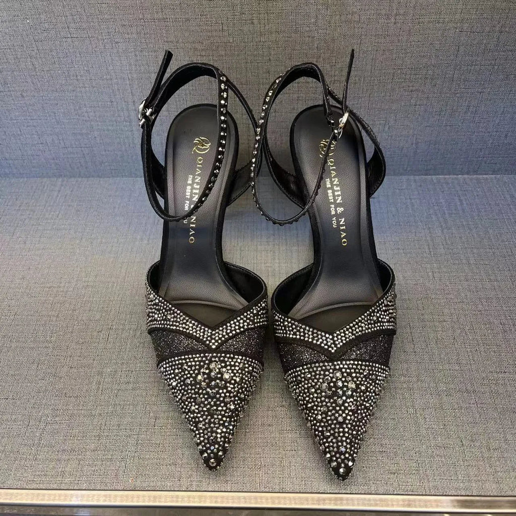 Women's silver hollow stiletto heels with pointed toe and red sole on white background