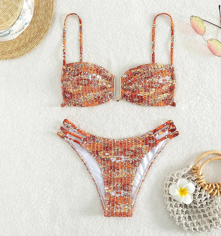 Women's high-waist floral bikini swimsuit on a hanger in blue, orange, pink, and rose red colours.