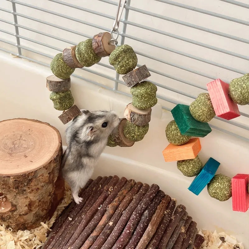 Applewood and straw ball ring chew toy for hamsters, guinea pigs, and rabbits on a white background.