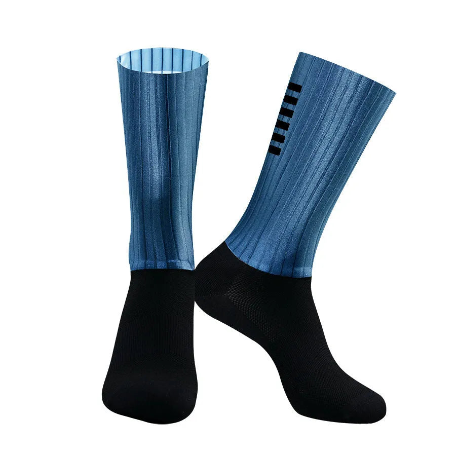 Pair of breathable athletic socks for running and cycling in orange colour on a grey background