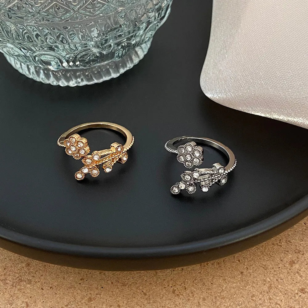 Women's open ring with diamond-treated flower and leaf designs on copper in gold colour option